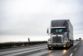 Large 18-wheeler truck driving on a highway