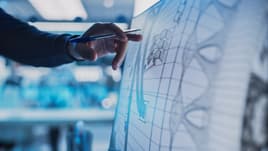 Design engineer looking at a screen of blueprints for a final products