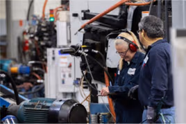 Dynacast employees checking for quality assurance