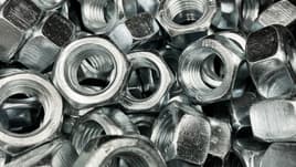 Shiny die cast nuts in a pile