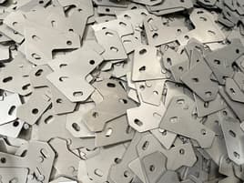 Pile of die cast metal plates