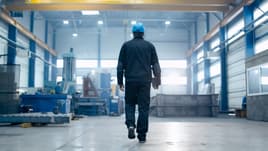 Manufacturing employee walking through a facility